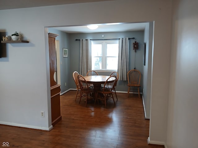 dining area with dark hardwood / wood-style flooring