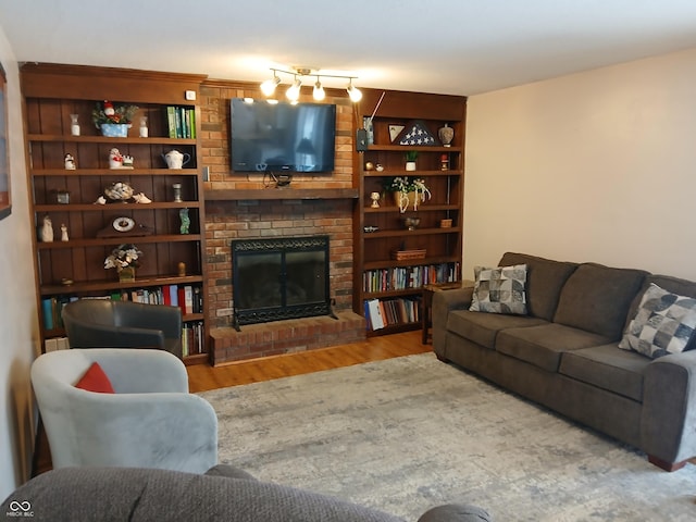 living room with hardwood / wood-style floors and a brick fireplace