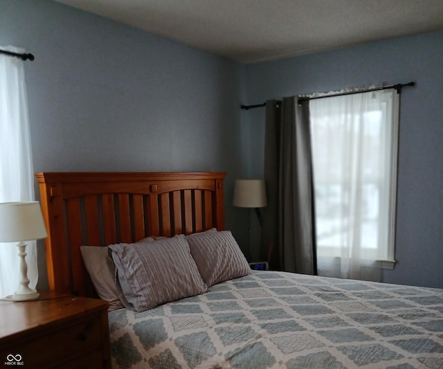 bedroom with multiple windows