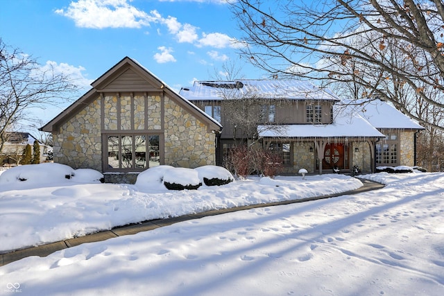 snow covered house featuring french doors