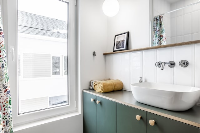 bathroom featuring vanity and a shower with shower curtain