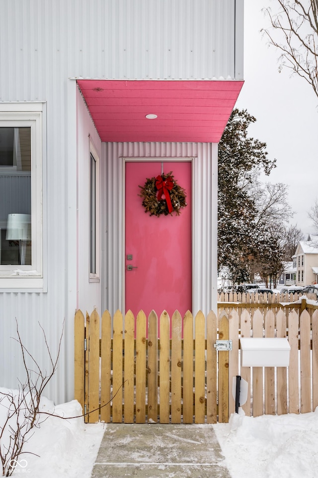 view of snow covered property entrance