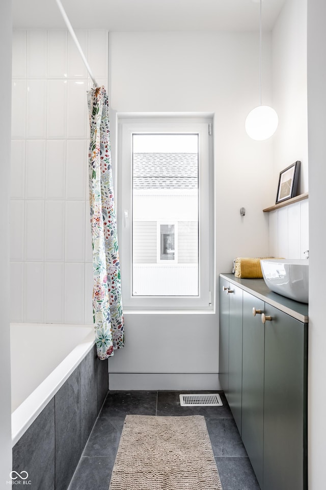 bathroom with tile patterned flooring, vanity, and shower / tub combo