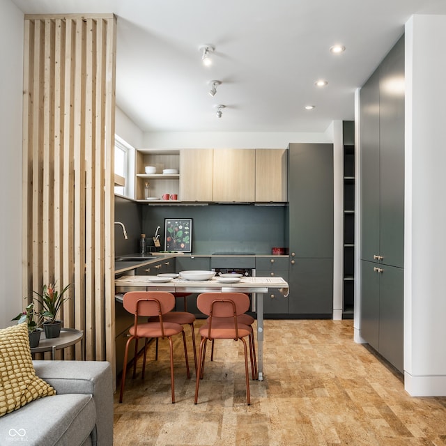 kitchen with light brown cabinetry and sink