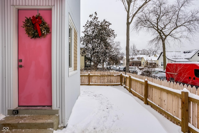 view of snow covered property entrance