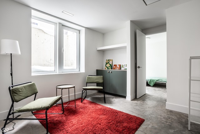 living area with concrete flooring