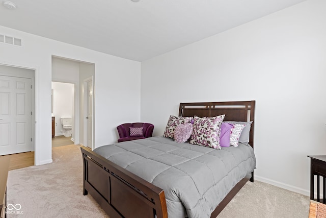 bedroom featuring carpet, connected bathroom, visible vents, and baseboards