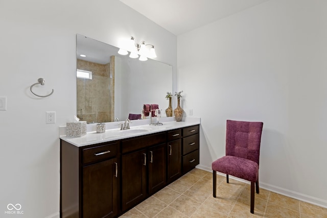 full bath with tile patterned floors, baseboards, a tile shower, and vanity