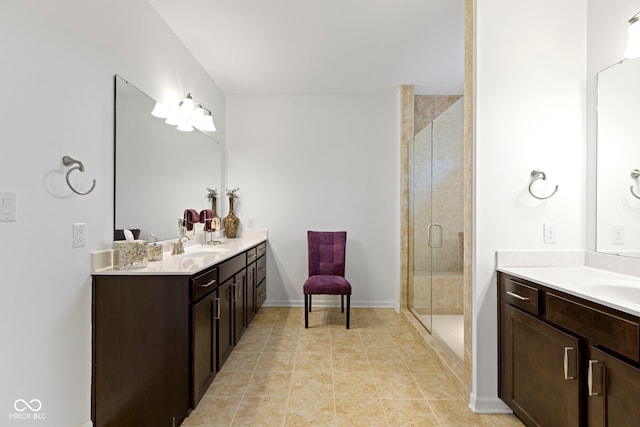 full bathroom featuring a sink, tile patterned floors, two vanities, and a shower stall