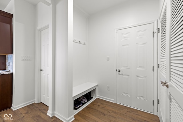 mudroom featuring baseboards and dark wood finished floors