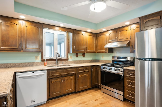 kitchen featuring ceiling fan, light wood-type flooring, sink, and appliances with stainless steel finishes