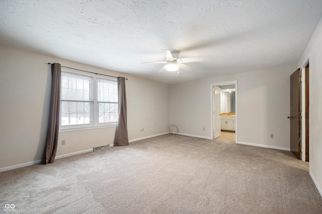 unfurnished room with light carpet, a textured ceiling, and ceiling fan