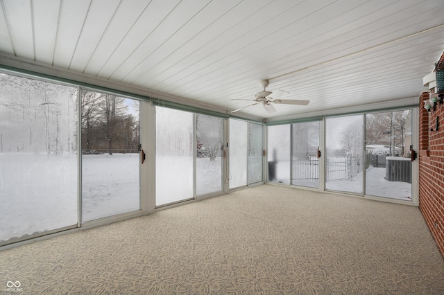 unfurnished sunroom with ceiling fan and a healthy amount of sunlight