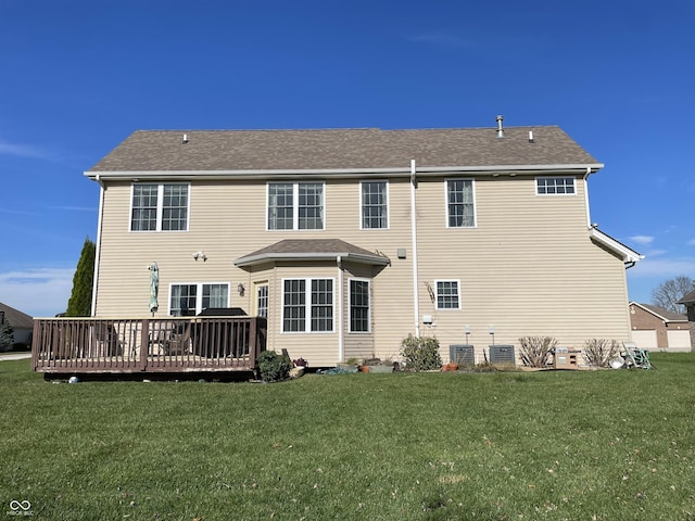 rear view of house featuring central air condition unit, a lawn, and a wooden deck