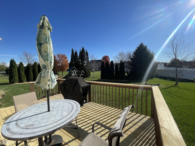 deck featuring a yard and grilling area