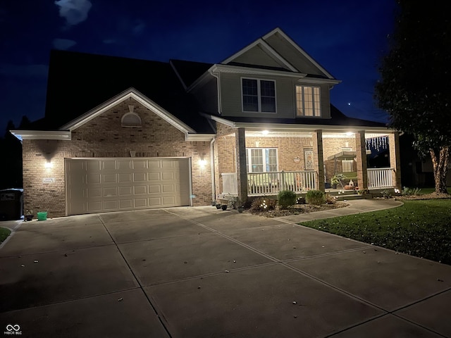 view of front of property featuring covered porch and a garage