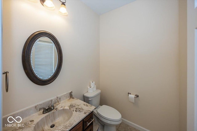 bathroom with tile patterned floors, vanity, and toilet