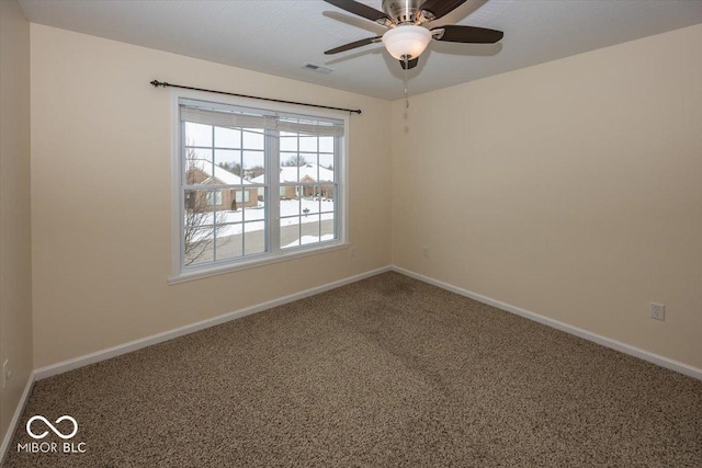 spare room with ceiling fan and carpet