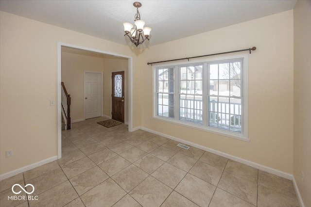 entryway featuring light tile patterned floors and a chandelier