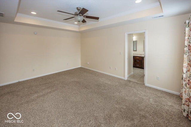 unfurnished room featuring light carpet, a raised ceiling, ceiling fan, and crown molding