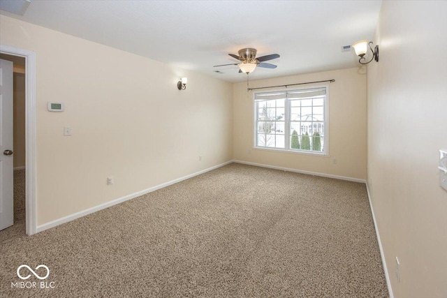 carpeted spare room featuring ceiling fan