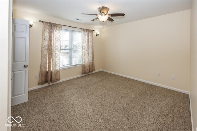 spare room featuring carpet flooring and ceiling fan