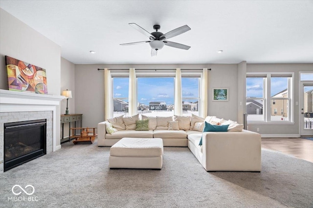 living room with ceiling fan, light carpet, and a brick fireplace