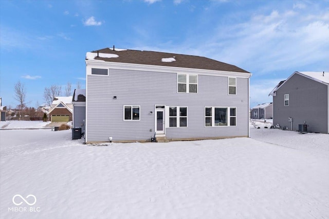 view of snow covered back of property