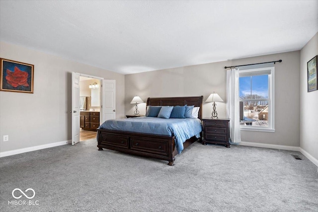 carpeted bedroom featuring ensuite bathroom