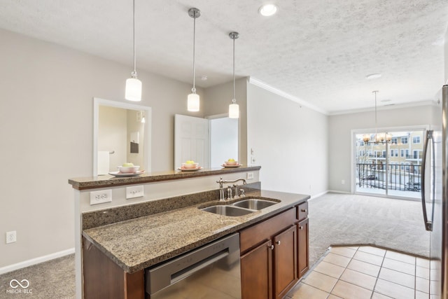 kitchen featuring sink, light colored carpet, decorative light fixtures, and appliances with stainless steel finishes