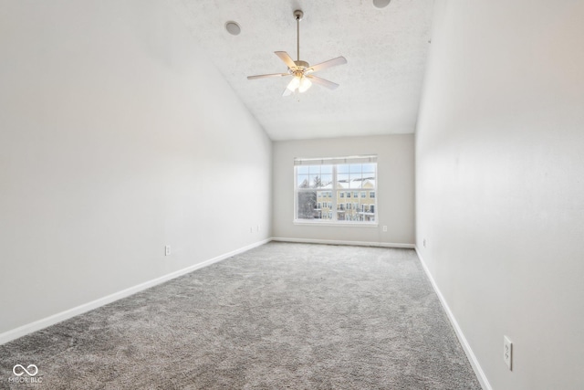 spare room featuring ceiling fan, carpet, and lofted ceiling