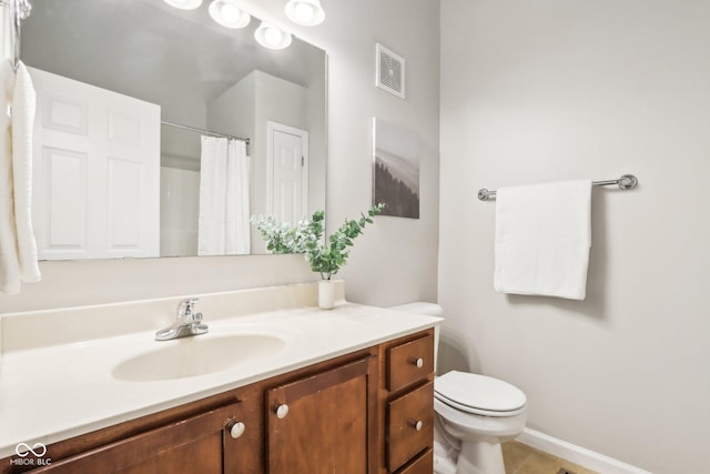 bathroom featuring tile patterned flooring, vanity, a shower with shower curtain, and toilet