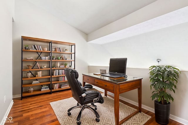 office space featuring wood-type flooring and vaulted ceiling