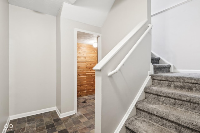 staircase with wooden walls