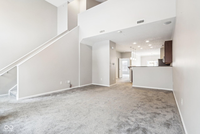 unfurnished living room with light colored carpet