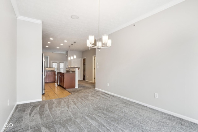 interior space with stainless steel refrigerator, an inviting chandelier, pendant lighting, light carpet, and a kitchen island