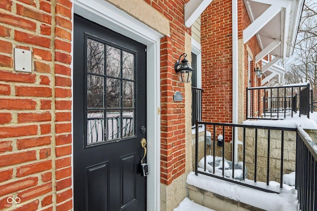 view of snow covered property entrance