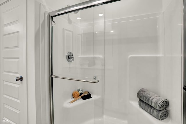 bathroom with a shower with shower door