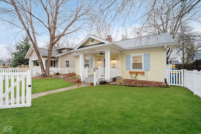 bungalow-style house with covered porch, a front lawn, and ceiling fan