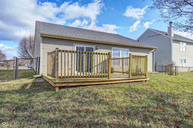 rear view of property featuring a yard and a deck