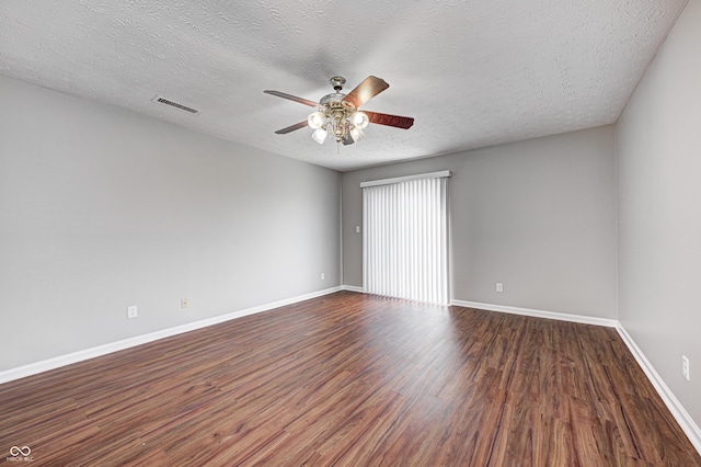 empty room with ceiling fan, hardwood / wood-style floors, and a textured ceiling