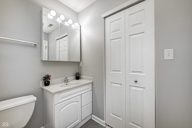 bathroom featuring vanity and toilet