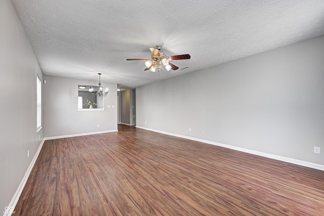 unfurnished room with ceiling fan with notable chandelier, dark hardwood / wood-style flooring, and a textured ceiling