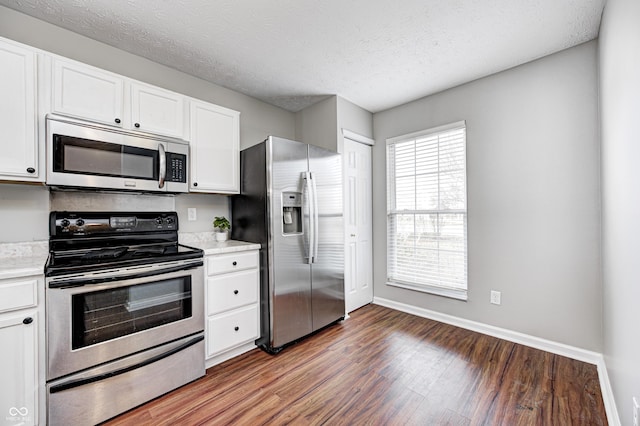 kitchen featuring white cabinets, dark hardwood / wood-style floors, a textured ceiling, and appliances with stainless steel finishes