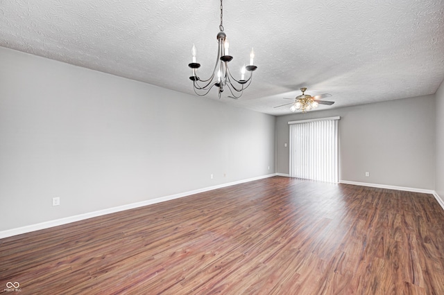 spare room featuring hardwood / wood-style flooring, ceiling fan with notable chandelier, and a textured ceiling