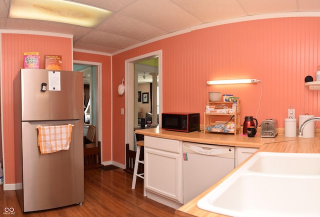 kitchen with hardwood / wood-style floors, dishwasher, sink, stainless steel fridge, and white cabinetry