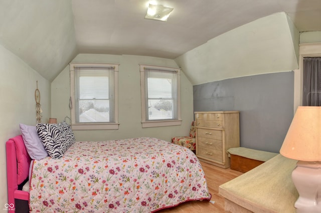 bedroom featuring light hardwood / wood-style floors and vaulted ceiling