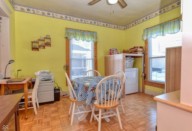 dining space with ceiling fan, light parquet flooring, and washer / dryer