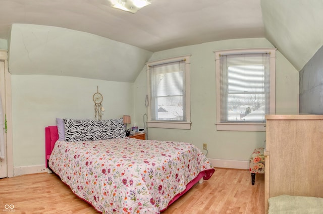 bedroom featuring vaulted ceiling and light hardwood / wood-style flooring