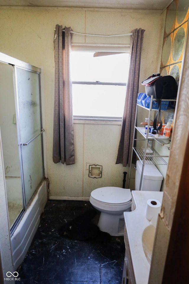 full bathroom with vanity, toilet, and enclosed tub / shower combo